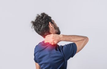 man suffering from neck pain.