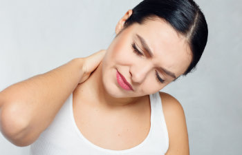woman holds her neck with pain