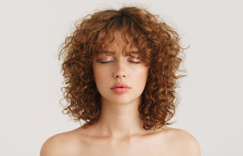 calm woman with curly red hair